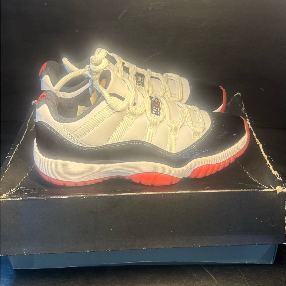 Jordan 11 low White and Black Sneakers with Red Accents